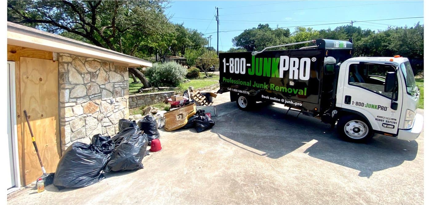 Before: black trash bags, an old crate and scrap piled against a stone garage, the JUNKPRO truck pulled up on the driveway.